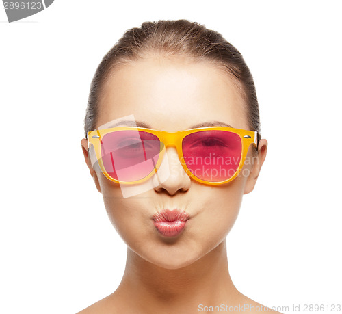 Image of girl in pink sunglasses blowing kiss