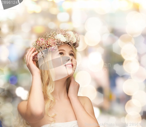 Image of young woman wearing wreath of flowers