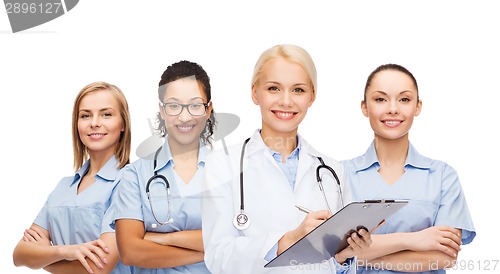 Image of smiling female doctor and nurses with stethoscope