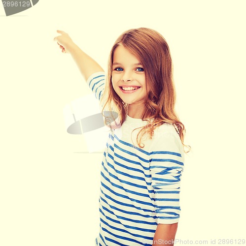 Image of smiling girl pointing at virtual screen