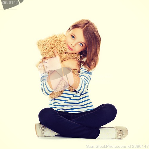 Image of cute little girl hugging teddy bear