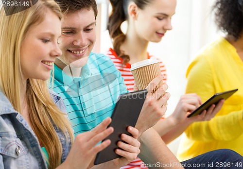 Image of smiling students with tablet pc at school