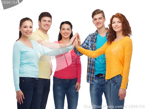 Image of smiling teenagers making high five