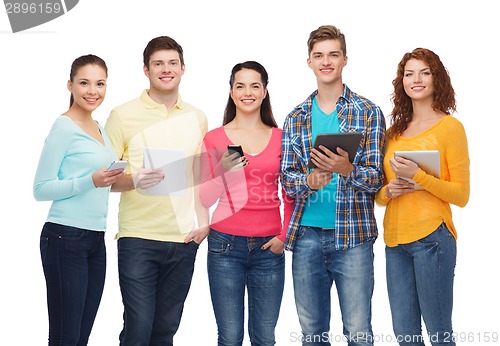 Image of group of teenagers with smartphones and tablet pc