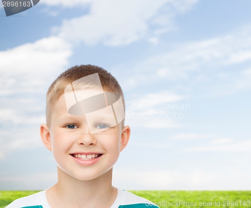 Image of smiling little boy over natural background