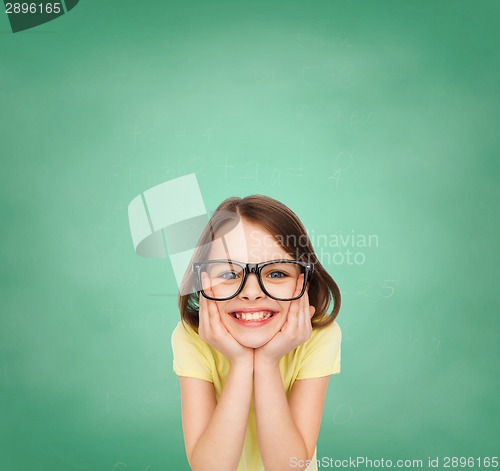 Image of smiling cute little girl in black eyeglasses