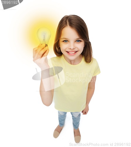 Image of smiling little girl holding light bulb