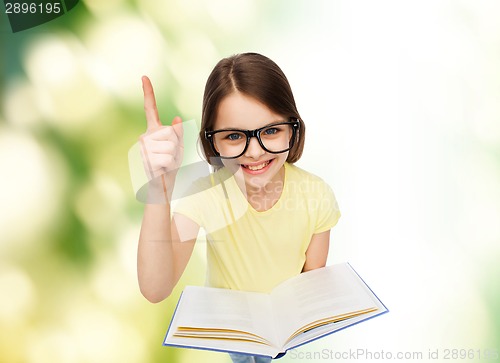 Image of smiling little girl in eyeglasses with book