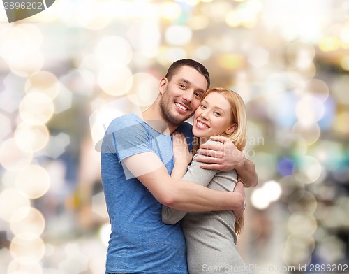 Image of smiling couple hugging