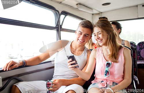 Image of smiling couple with smartphone making selfie