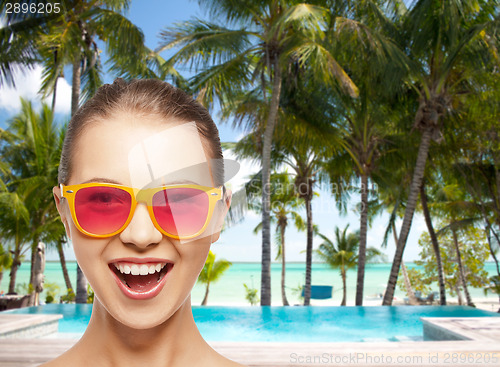 Image of happy teenage girl in pink sunglasses