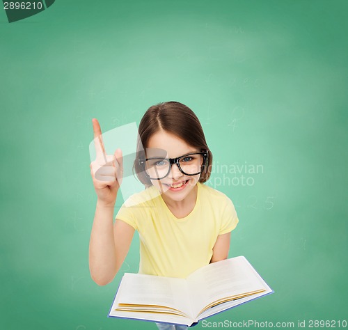 Image of smiling little girl in eyeglasses with book