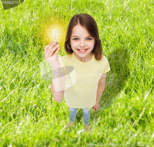 Image of smiling little girl holding light bulb