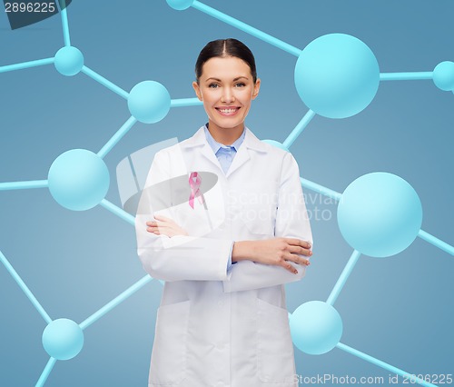 Image of smiling female doctor with cancer awareness ribbon