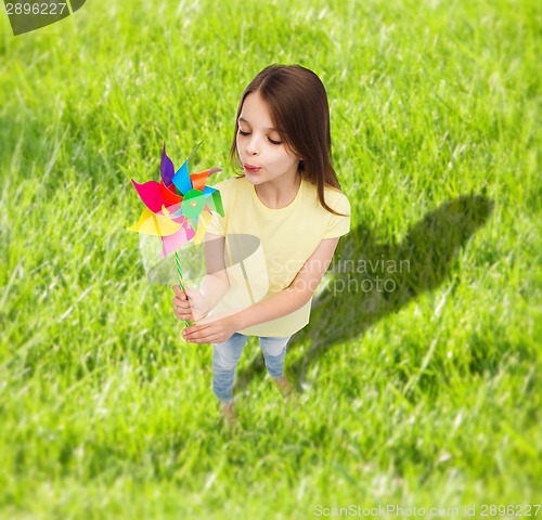 Image of smiling child with colorful windmill toy