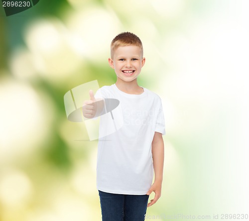 Image of smiling boy in white t-shirt showing thumbs up
