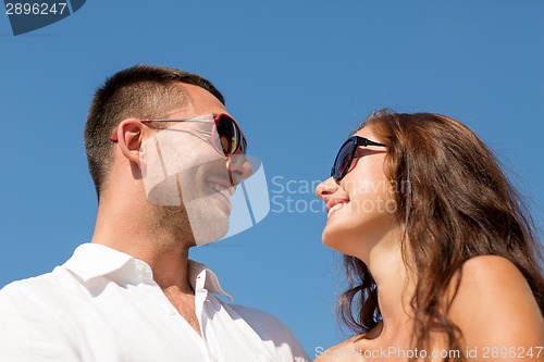 Image of smiling couple over blue sky background