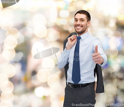 Image of smiling young businessman showing thumbs up