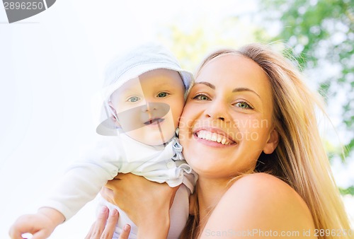 Image of happy mother with little baby outdoors