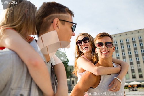 Image of smiling couple having fun in city