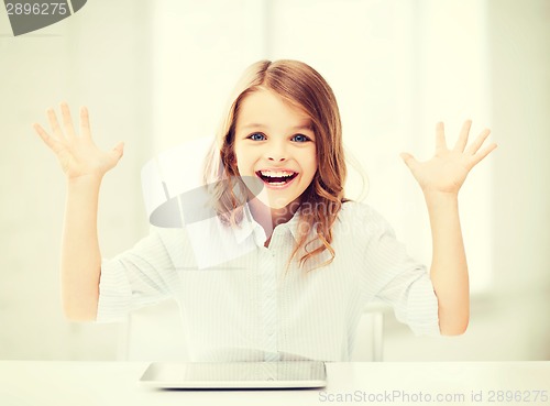 Image of laughing girl with tablet pc computer and hands up