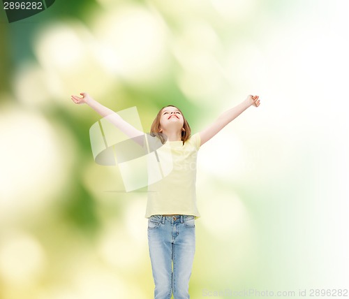 Image of smiling teenage girl with raised hands