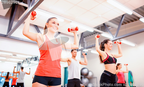 Image of group of people working out with dumbbells