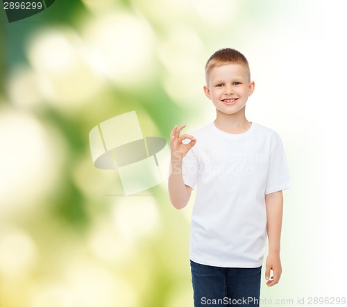 Image of little boy in white t-shirt making ok gesture