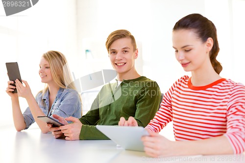 Image of smiling students with tablet pc at school