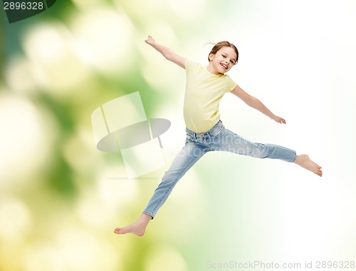 Image of smiling little girl jumping