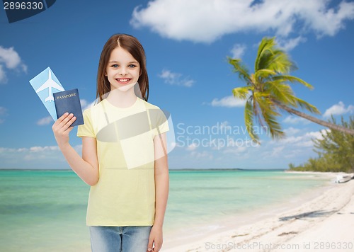 Image of smiling little girl with ticket and passport