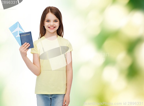 Image of smiling little girl with ticket and passport