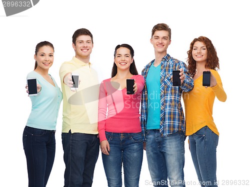 Image of group of smiling teenagers with smartphones