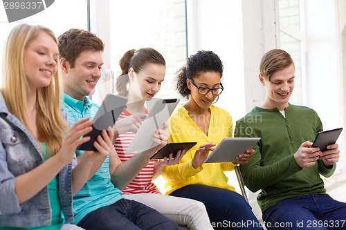 Image of smiling students with tablet pc at school