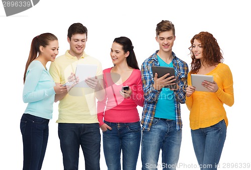 Image of group of teenagers with smartphones and tablet pc