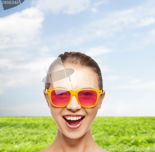 Image of happy teenage girl in pink sunglasses