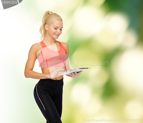 Image of smiling sporty woman with tablet pc computer