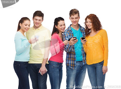 Image of group of smiling teenagers with smartphones
