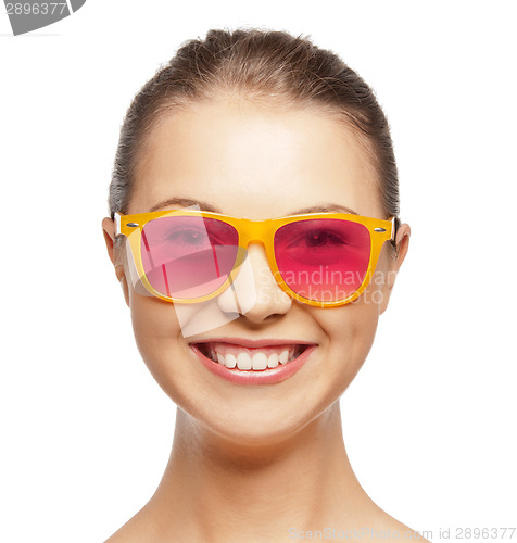 Image of smiling teenage girl in pink sunglasses