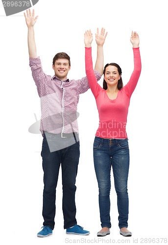 Image of smiling teenagers with raised hands