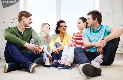 Image of five smiling teenagers having fun at home