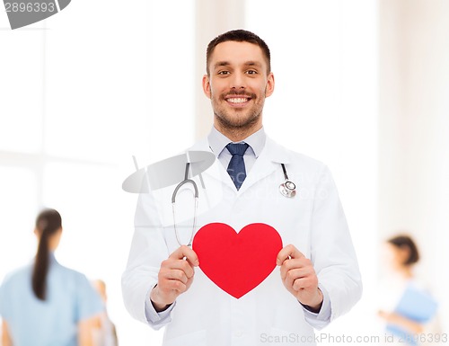 Image of smiling male doctor with red heart