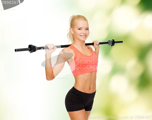 Image of smiling sporty woman exercising with barbell