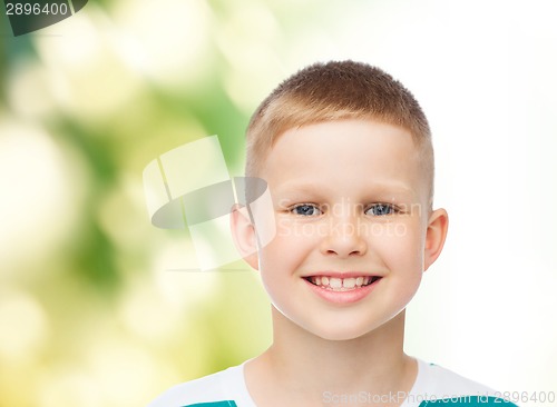 Image of smiling little boy over green background