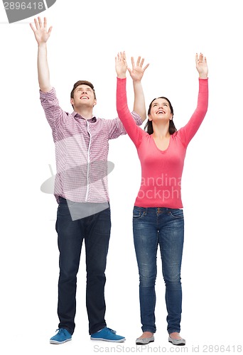 Image of smiling teenagers with raised hands