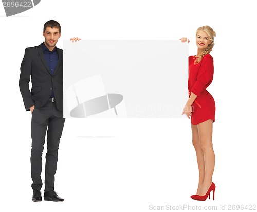 Image of couple holding big blank white board