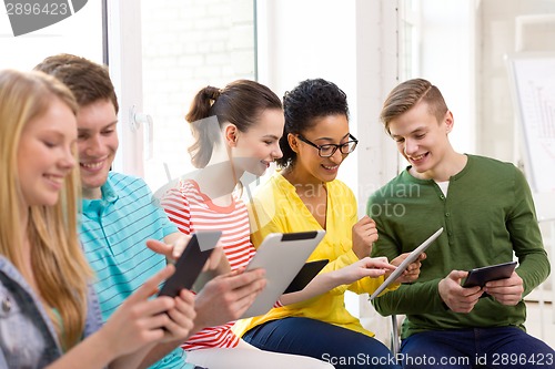 Image of smiling students with tablet pc at school