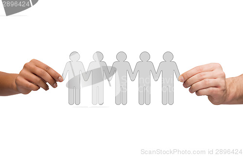 Image of hands holding paper chain people