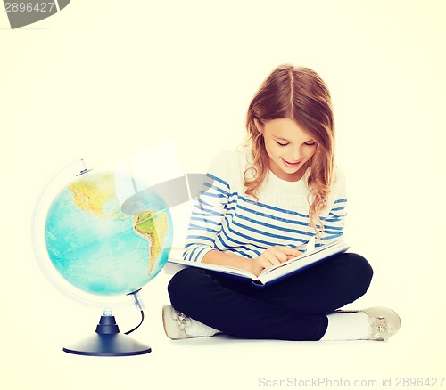 Image of girl with globe and book