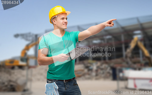 Image of smiling man in helmet with clipboard